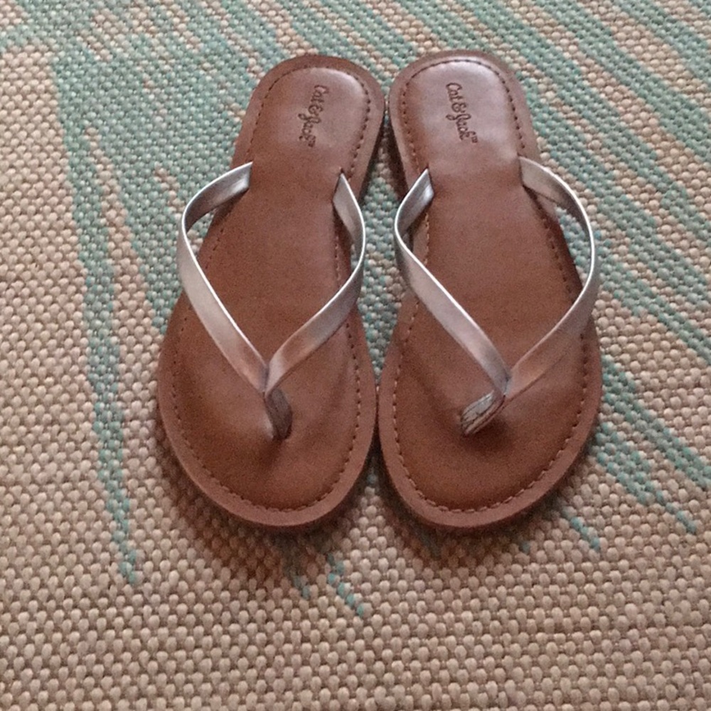 Tan and silver flip flops